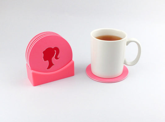 Barbie Style Coasters in a stand next to a cup of tea