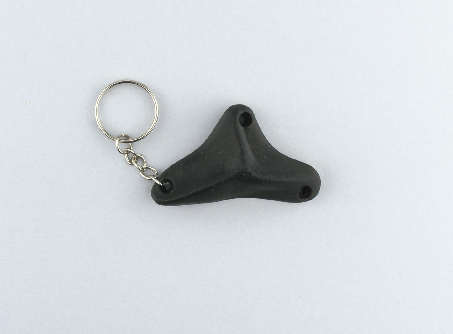 A Black Climbing Hold keychain