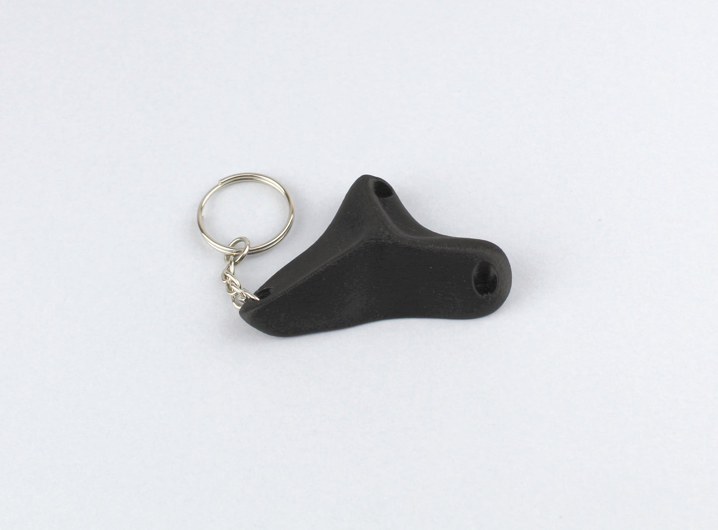 A Black Climbing Hold keychain