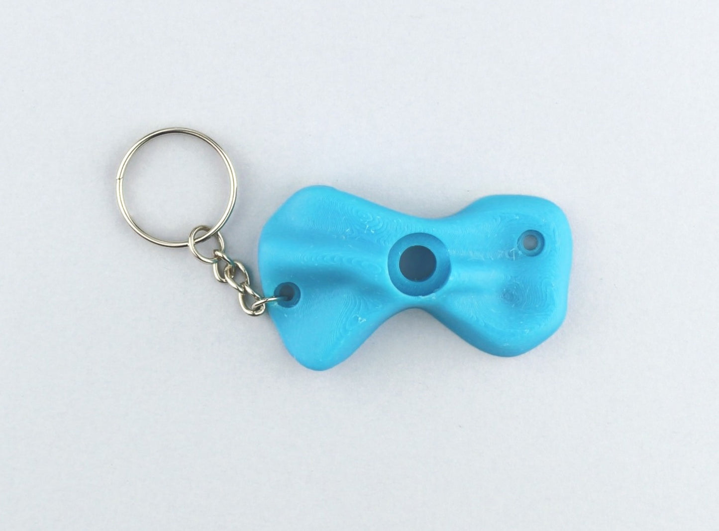 A Light Blue Climbing Hold keychain