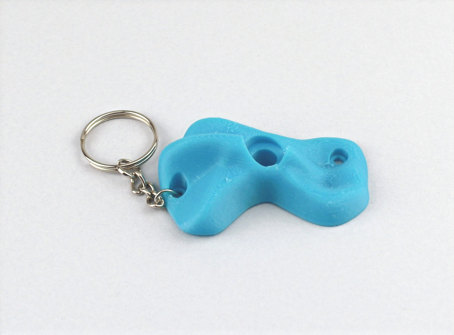 A Light Blue Climbing Hold keychain