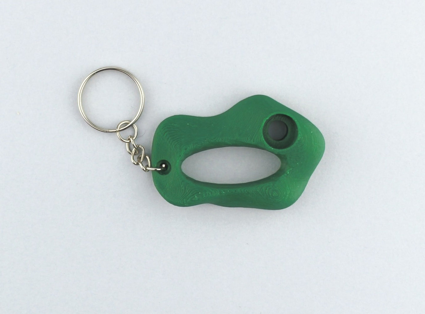 A Green Climbing Hold keychain