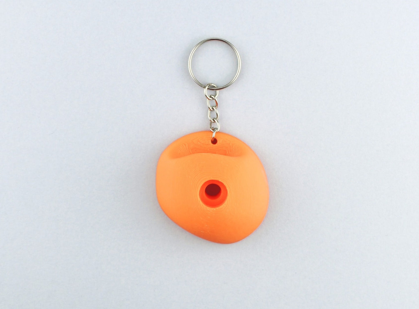 An Orange Climbing Hold keychain