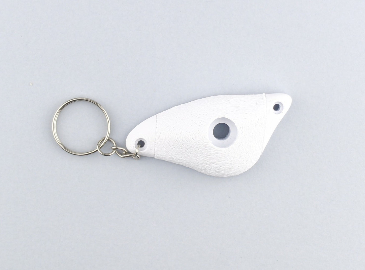 A White Climbing Hold keychain