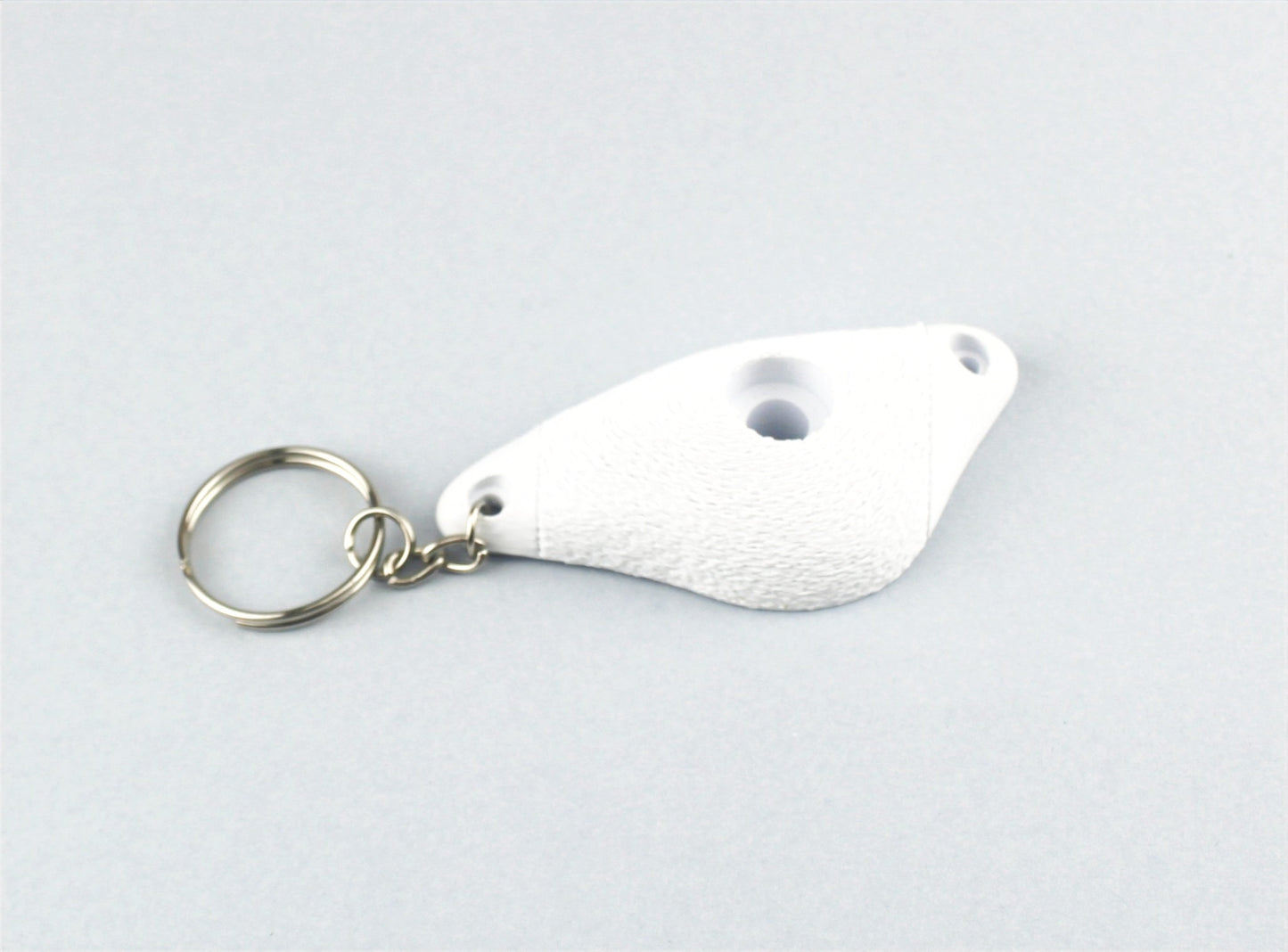 A White Climbing Hold keychain
