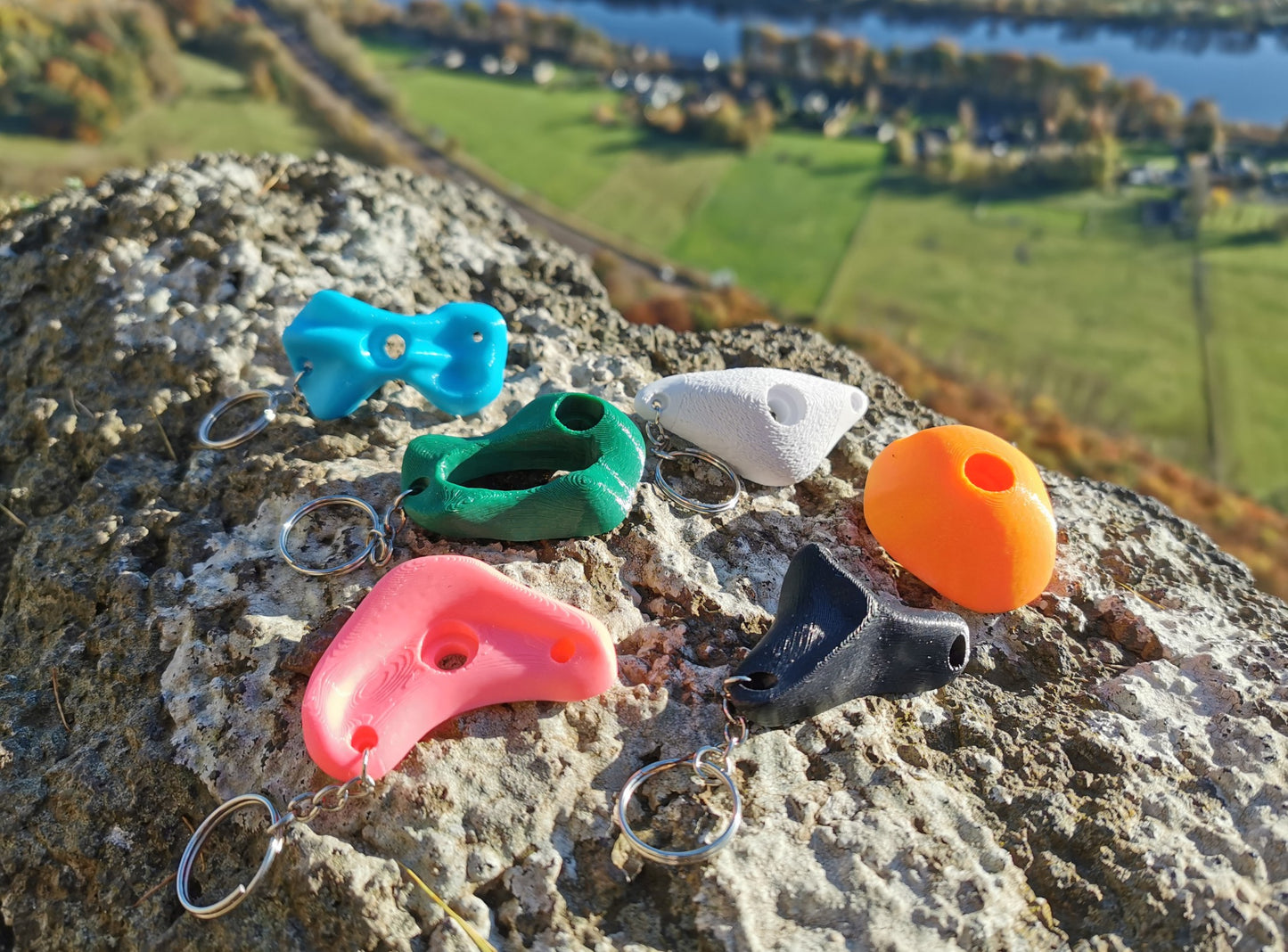 3D Printed Climbing Holds keychains on a rock