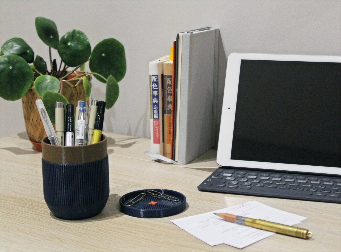 Desk with an iPad and a pen holder full of pens