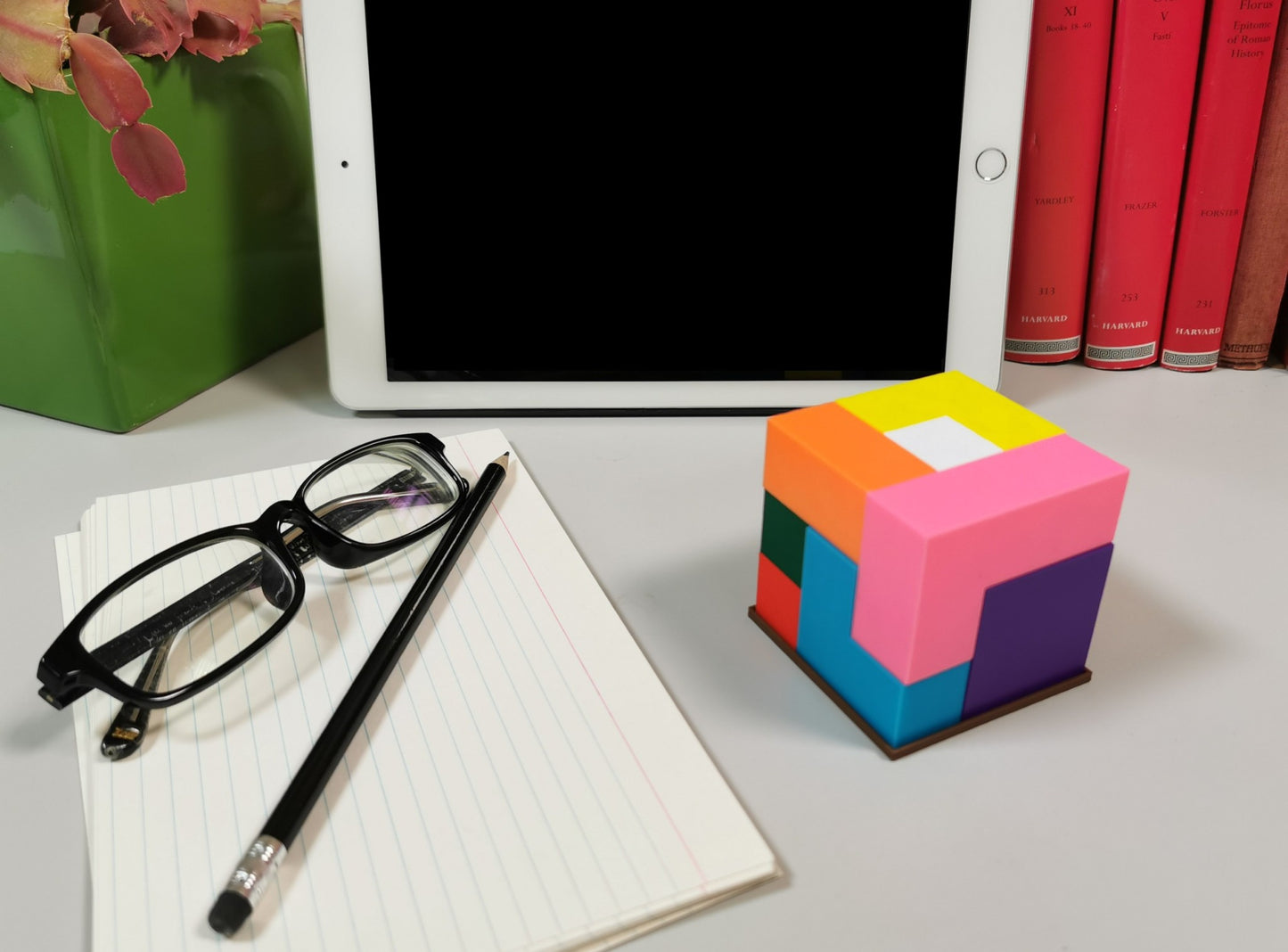 3D Printed Puzzle Cube On a Desk, next to an iPad