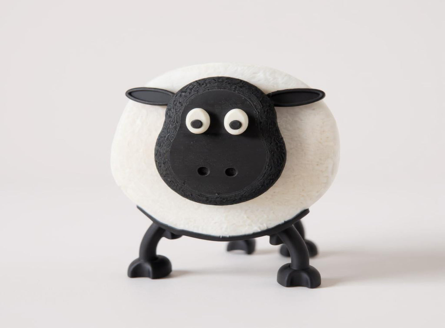 Black and white Sheep Toilet Roll Holder on a light gray background