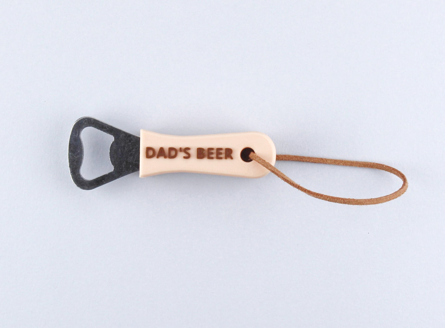 Beige Personalised Bottle Opener with the inscription DAD'S BEER in Brown and a Leather Strap
