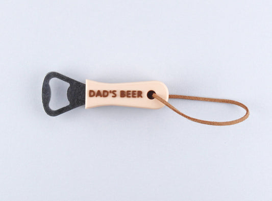 Beige Personalised Bottle Opener with the inscription DAD'S BEER in Brown and a Leather Strap