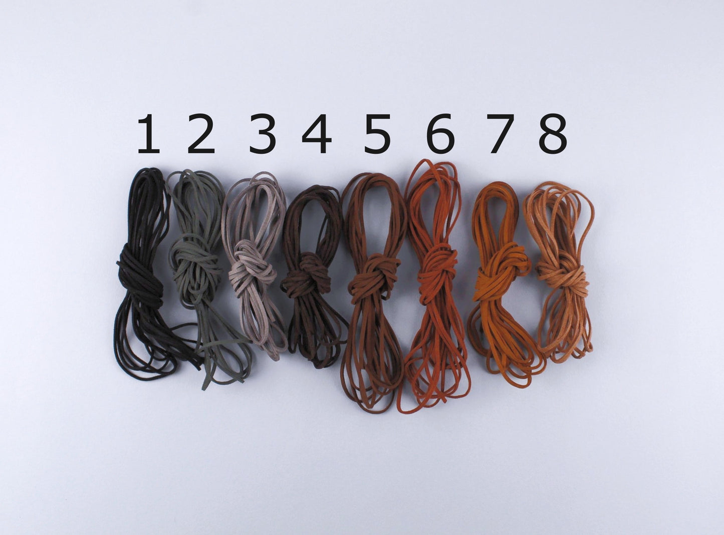 Eight stacks of thin leather strips in different colours