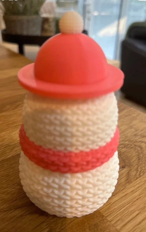 Knitted Effect Snowman Decoration with a red hat and scarf on a wooden surface