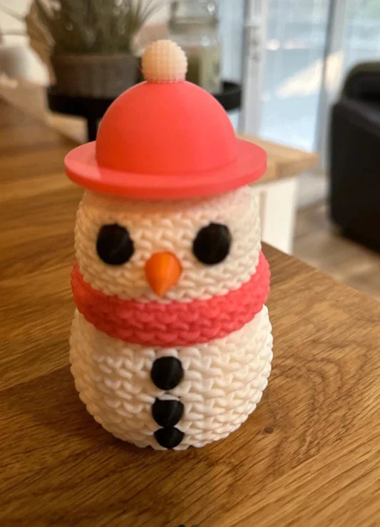 Knitted Effect Snowman Decoration with a red hat and scarf on a wooden surface