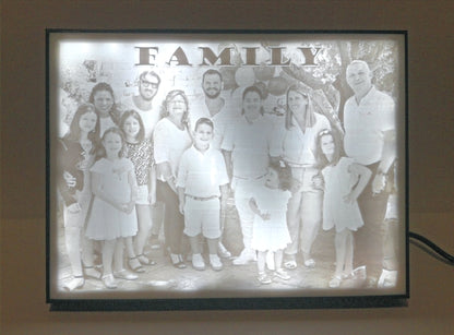 A lit Lithophane lamp, showing a black and white photo of a family with the caption Family