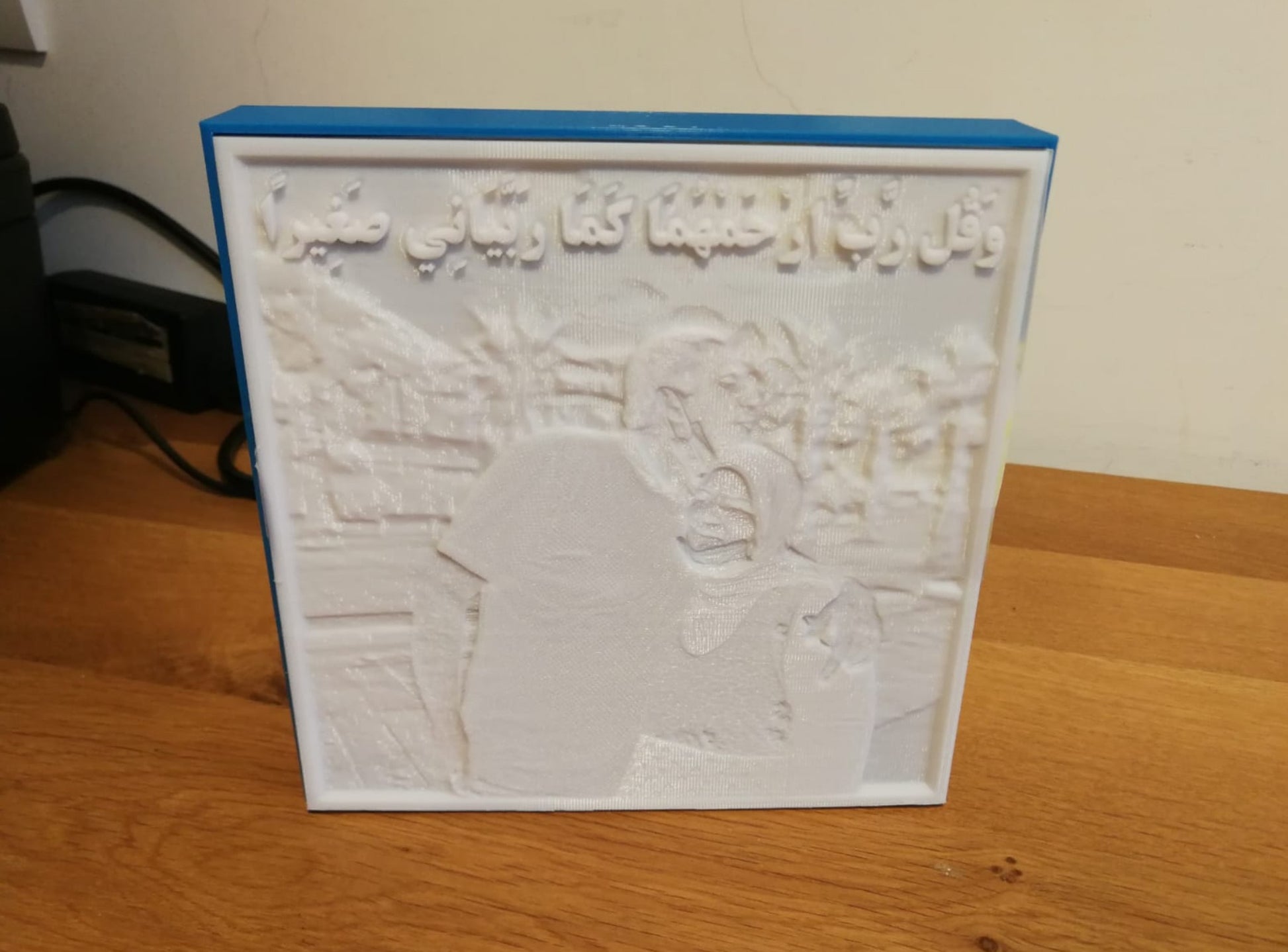 Lithophane lamp turned off, showing a three-dimensional outline of a couple with a caption