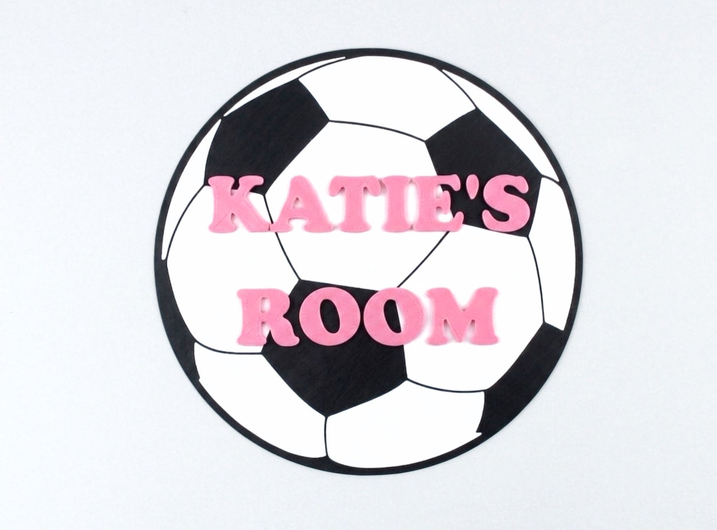 Soccer ball-shaped sign with 'KATIE'S ROOM' text on a white background