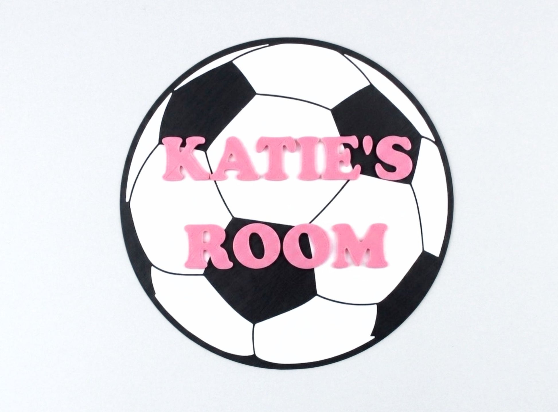 Soccer ball-shaped sign with 'KATIE'S ROOM' text on a white background
