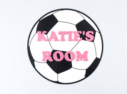 Soccer ball-shaped sign with 'KATIE'S ROOM' text on a white background