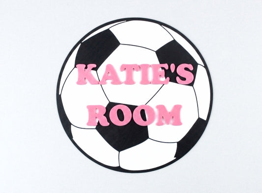 Soccer ball-shaped sign with 'KATIE'S ROOM' text on a white background