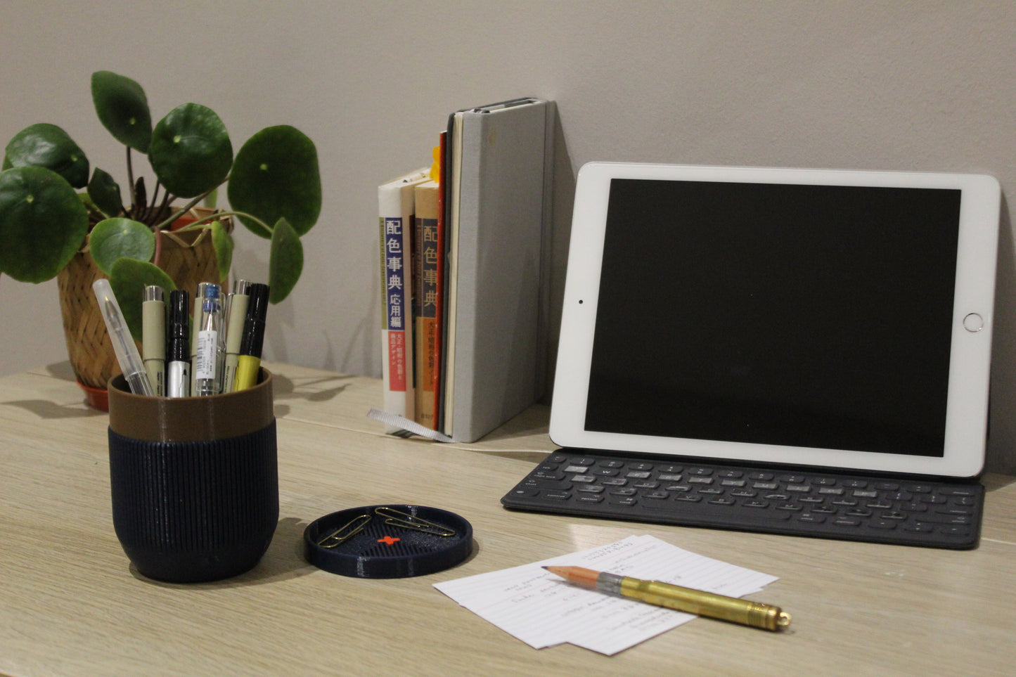 Desk with an iPad and a pen holder full of pens