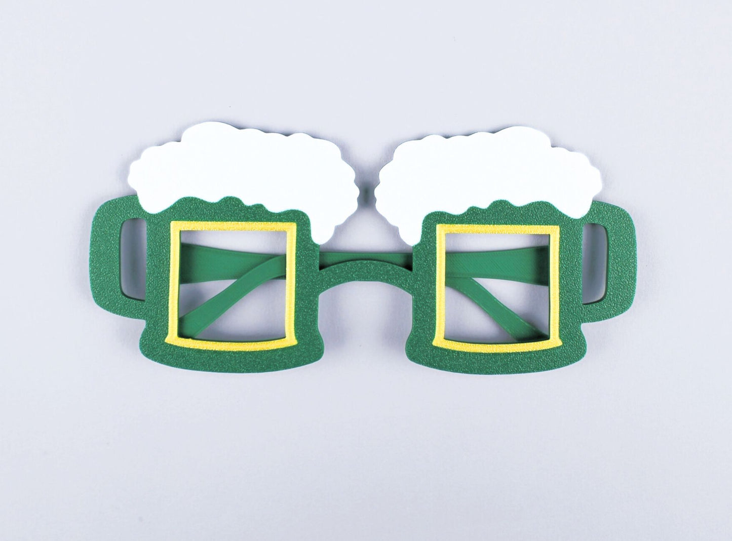 Green 3D-Printed St. Patrick's Day beer mug-shaped novelty glasses on a light gray background
