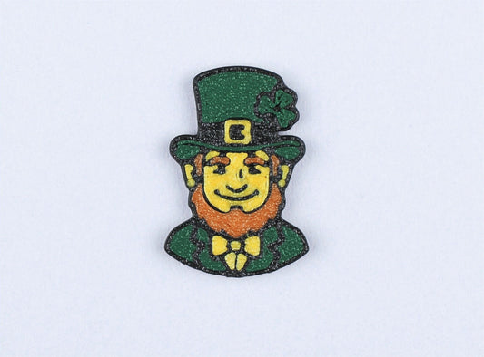 Leprechaun character pin with a green hat and bow tie on a light grey background