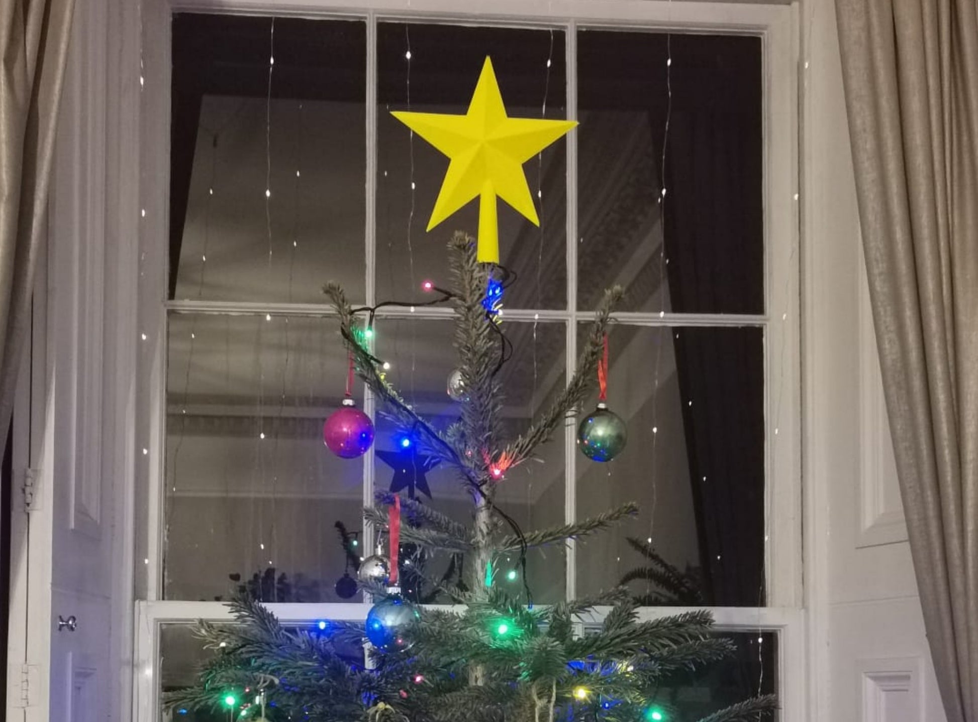 3D Printed Star Tree Topper on top of a christmas tree