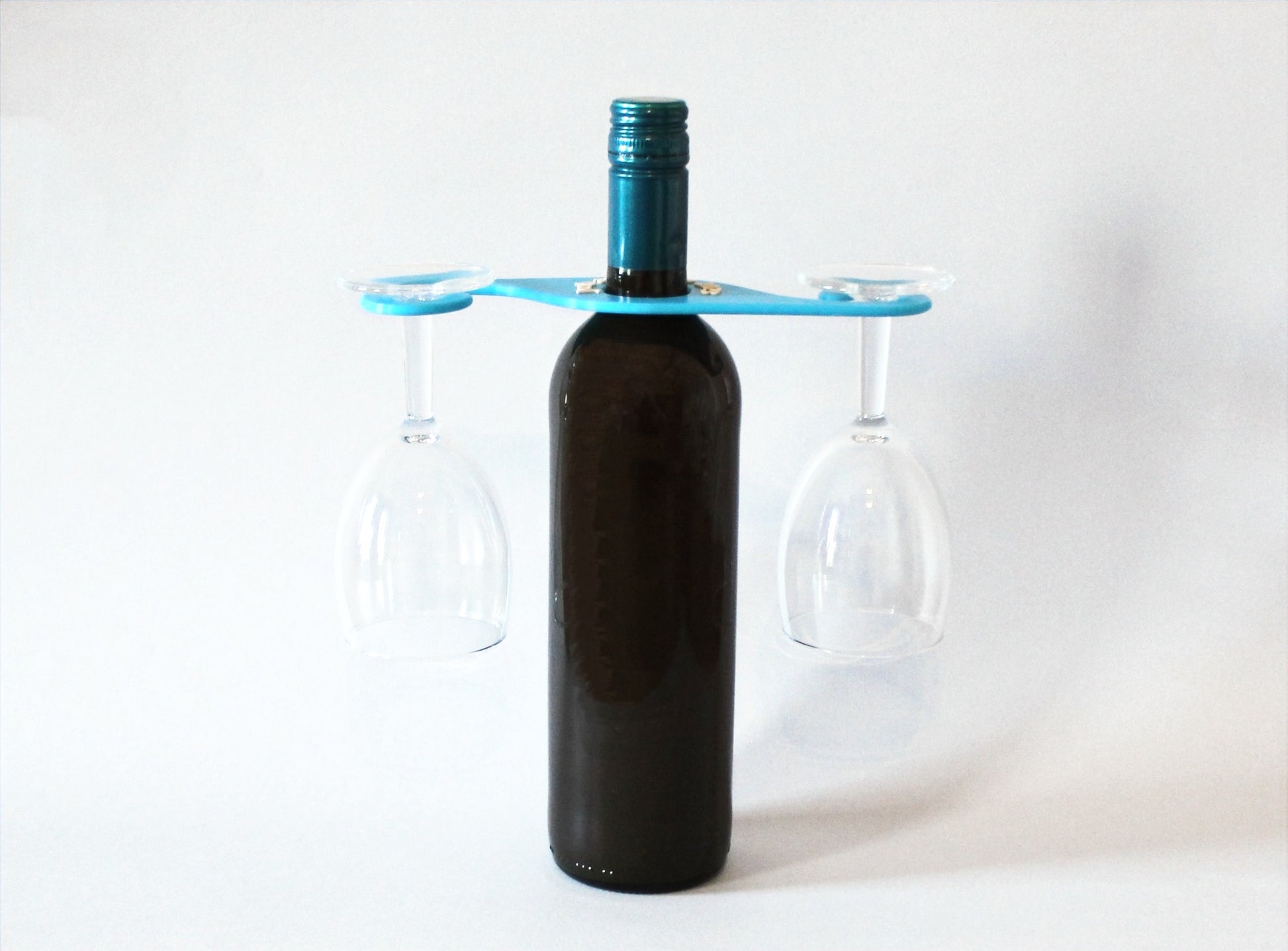 A wine bottle with a wine glass holder on it, with two glasses