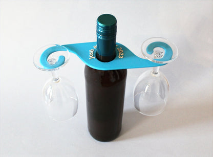 A wine bottle with a wine glass holder on it, with two glasses