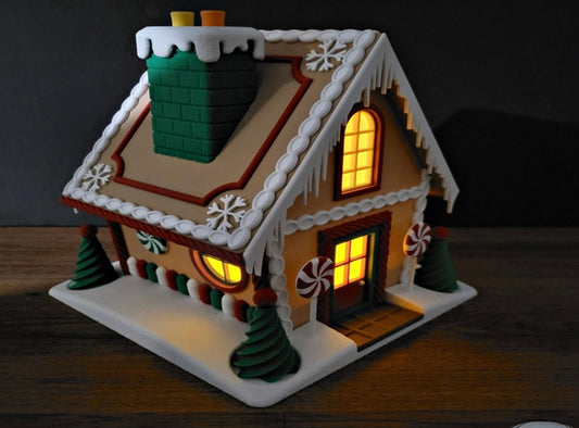 Decorative gingerbread house with lit windows on a dark background