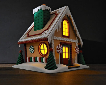 Decorative gingerbread house with lit windows on a dark background