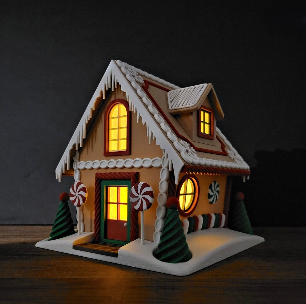 Decorative gingerbread house with lit windows on a dark background