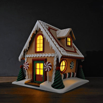 Decorative gingerbread house with lit windows on a dark background