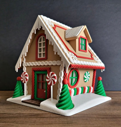 Decorative gingerbread house with candy cane trees on a wooden surface
