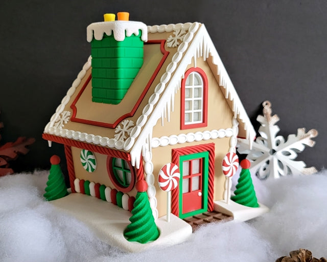 Decorative gingerbread house with candy decorations on a snowy background
