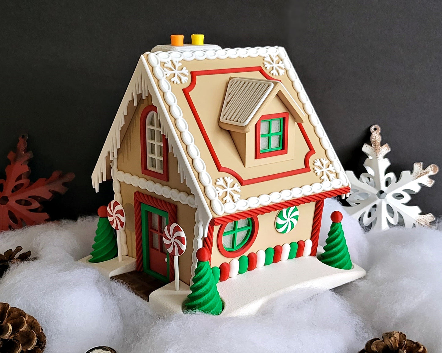 Decorative gingerbread house with candy decorations on a snowy background