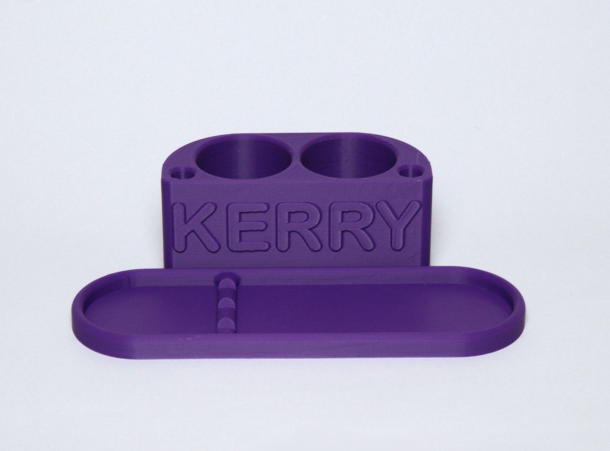 3D printed Purple Personalised Makeup Brush Holder with 'KERRY' branding on a light gray background