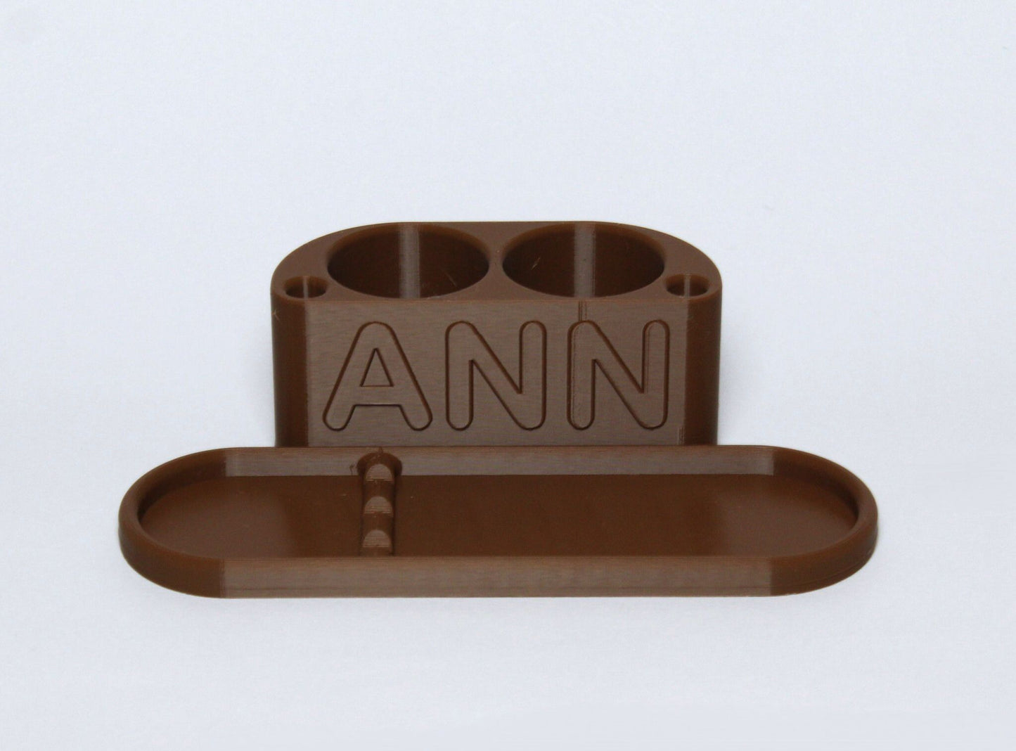 3D printed Brown Personalised Makeup Brush Holder with 'ANN' branding on a light gray background