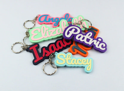3D Printed Colourful keychains with personalized names on a light gray background