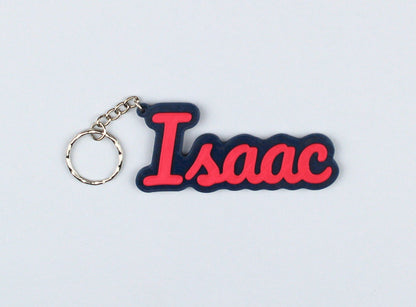 3D Printed Keychain with 'Isaac' in red letters on a blue background