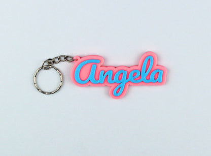 3D Printed Keychain with 'Angela' in pink and blue on a light gray background