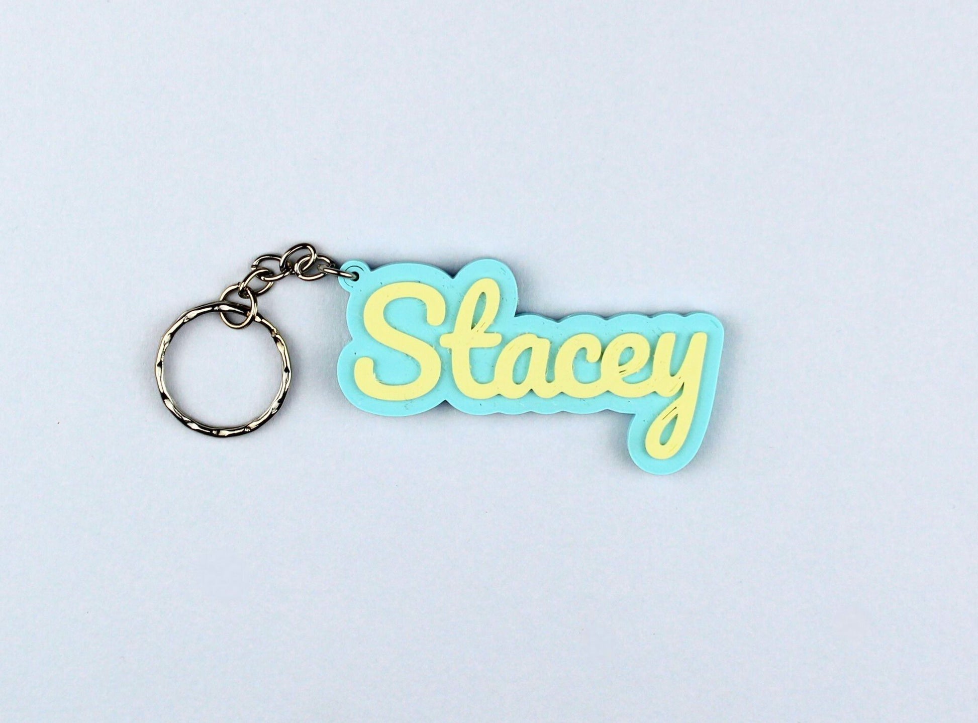 3D Printed Keychain with 'Stacey' on a light blue background