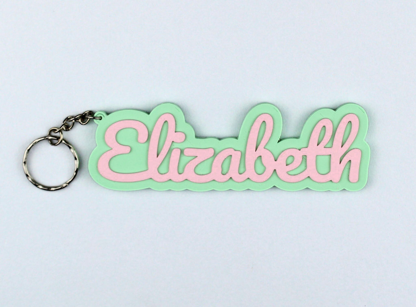 3D Printed Keychain with 'Elizabeth' in pink on a light green background
