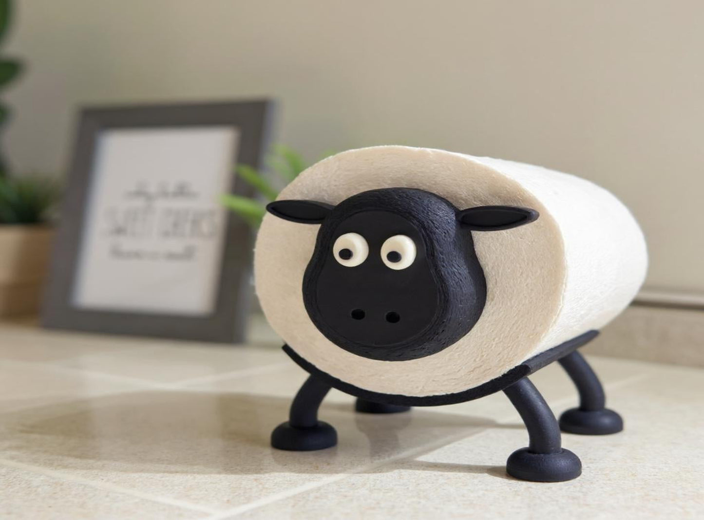 A Sheep Toilet Roll Holder with a blurred indoor background