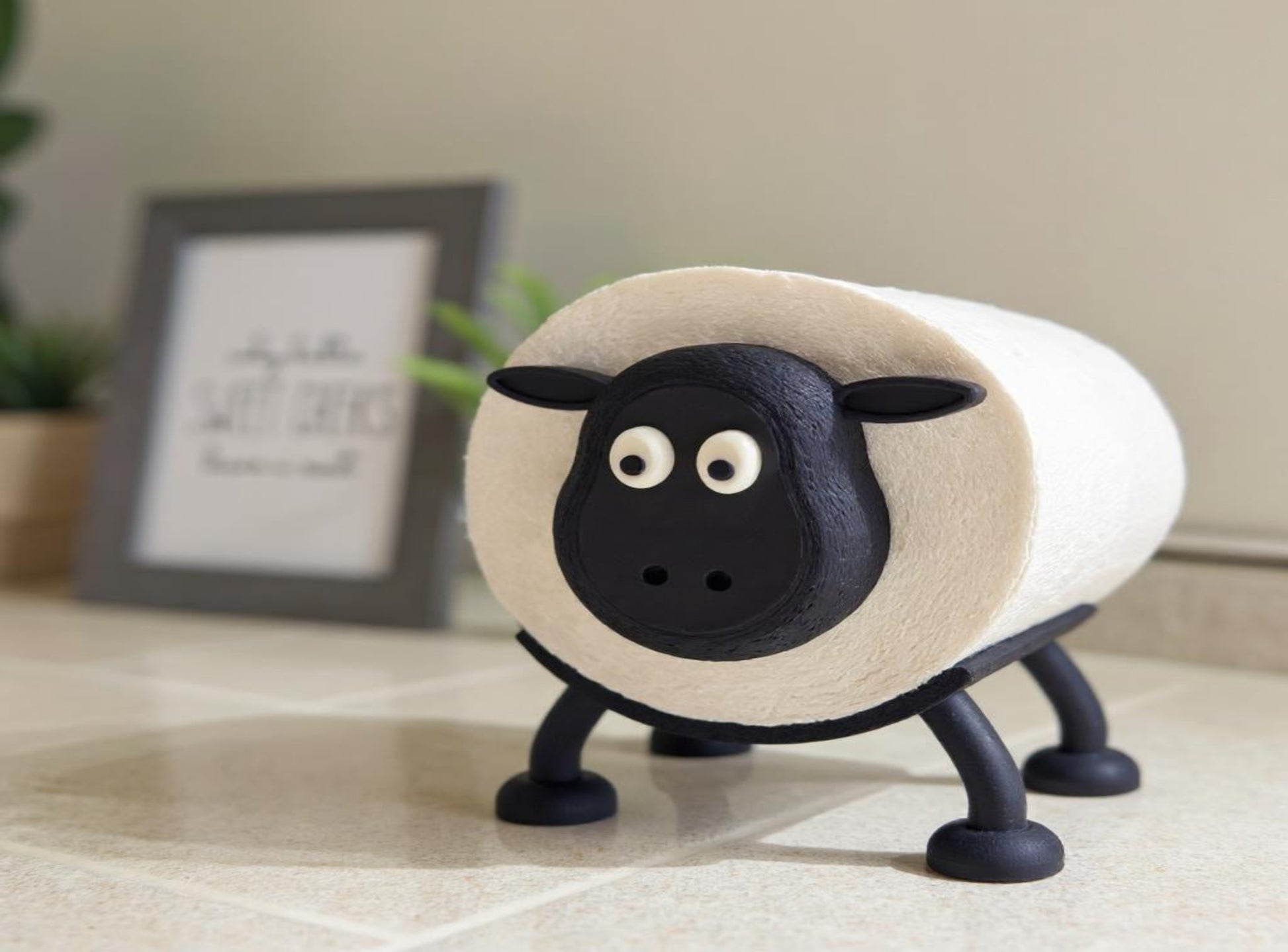 A Sheep Toilet Roll Holder with a blurred indoor background