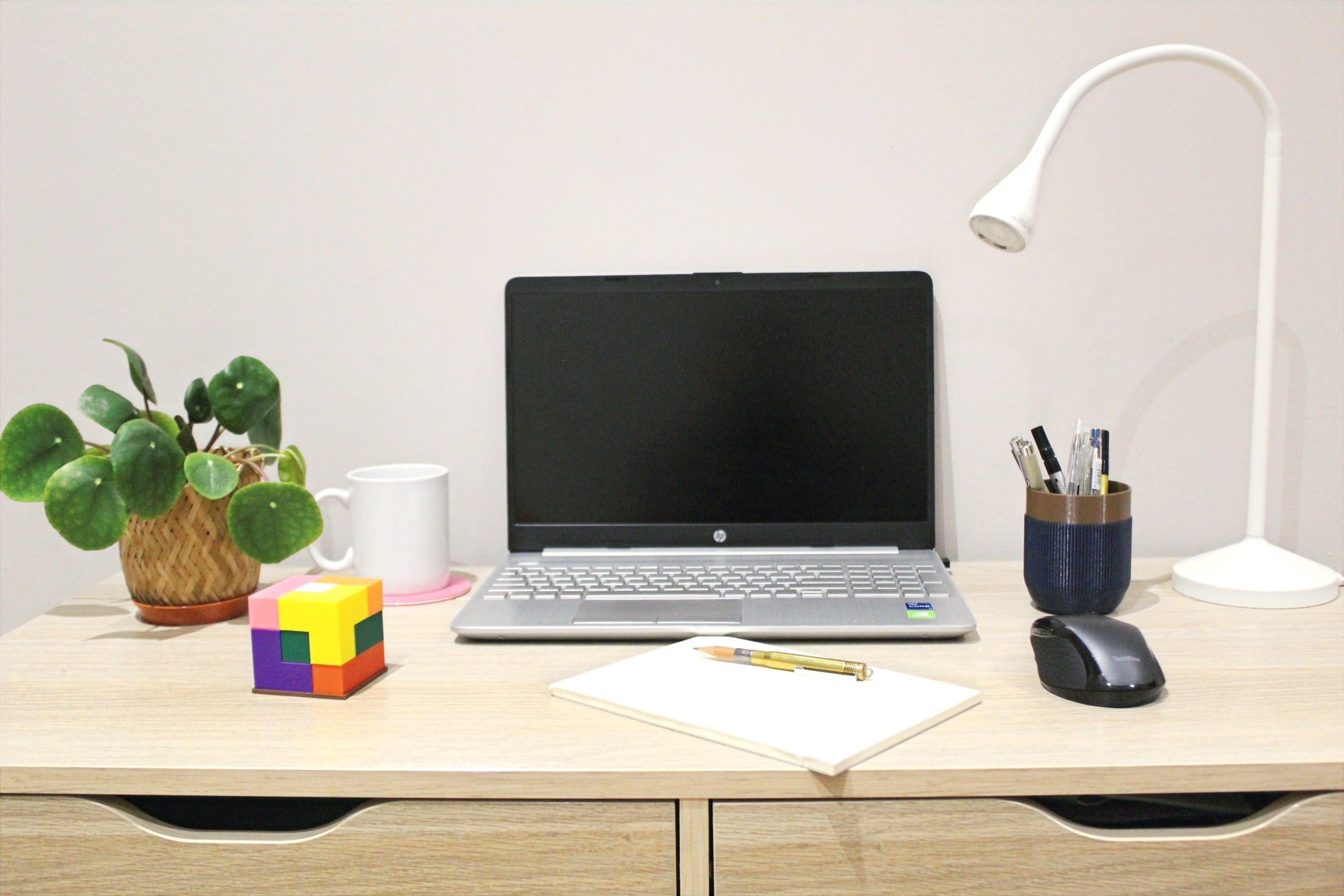 Desk with lamp, computer, mouse, puzzle cube and pen holder