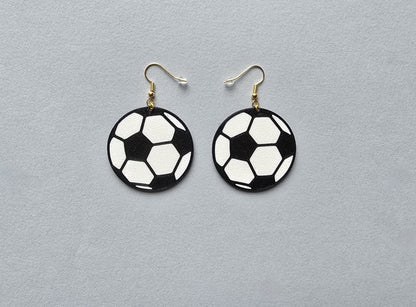 Football-shaped earrings on a gray background