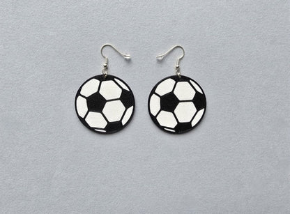 Soccer ball earrings on a gray background