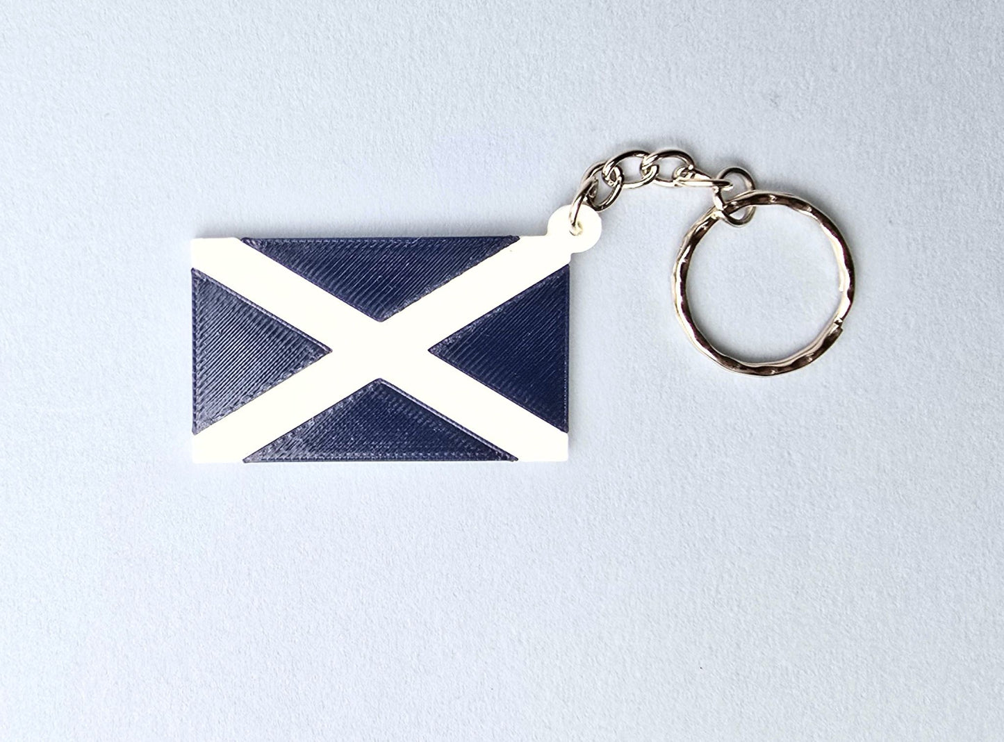 Keychain with Scotland flag design on a light gray background